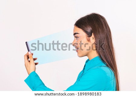 Biometric identification. Young beautiful woman scanning face with facial recognition system on smartphone.