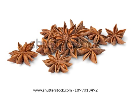 Heap of dried star anise close up isolated on white background  Royalty-Free Stock Photo #1899013492