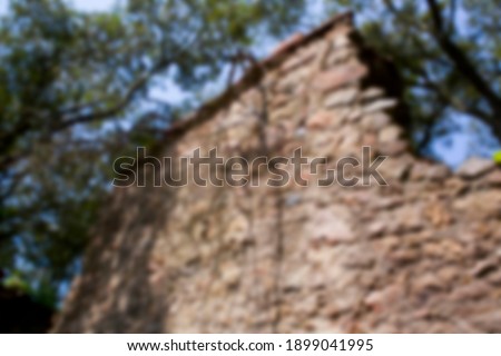 Blurred background of house ruins in the forest. 