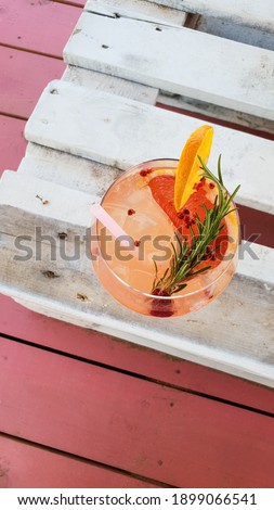 Grapefruit and rosemary gin cocktail, refreshing drink with  Crushed Ice, Mint and Lemon