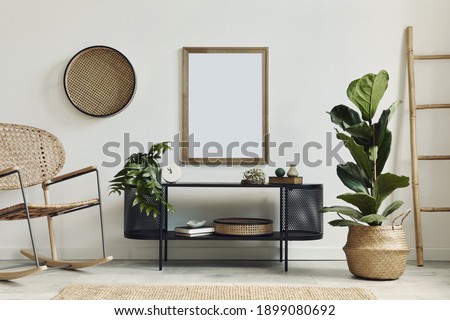 Modern scandinavian living room interior with mock up poster frame, design commode, plants, rattan armchair, book and elegant accessories in stylish home decor. Template. 