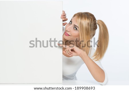Young woman showing card board and smiling looking at the camera