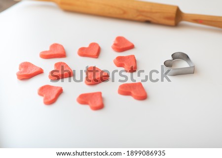 Shortcrust pastry with red dye for making cookies for Valentine's Day in the form of red hearts. cookie coloring.