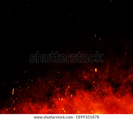 Fire embers particles over black background. Fire sparks background. Abstract dark glitter fire particles lights. bonfire in motion blur. Royalty-Free Stock Photo #1899101878