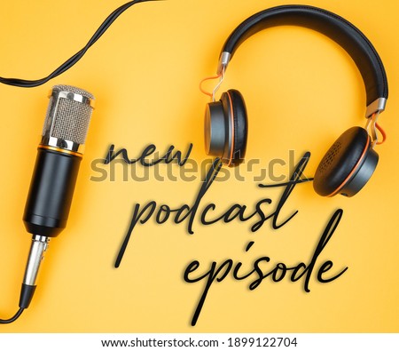 directly above view of microphone and headphones on orange background with text NEW PODCAST EPISODE, podcast recording concept Royalty-Free Stock Photo #1899122704