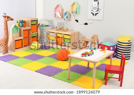Cute child's room interior with toys and modern furniture Royalty-Free Stock Photo #1899126079