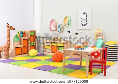 Cute child's room interior with toys and modern furniture Royalty-Free Stock Photo #1899126088