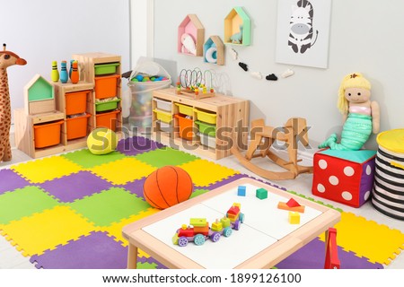 Cute child's room interior with toys and modern furniture Royalty-Free Stock Photo #1899126100