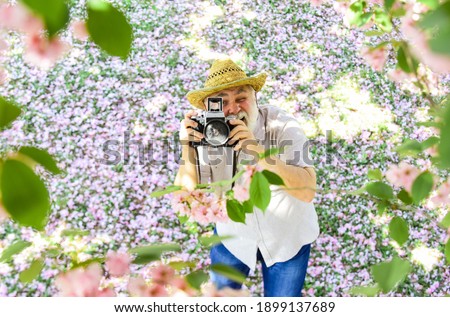 Grandfather photographer. Senior man holding professional camera. Vintage camera. Retro camera. Old happy man. Retirement Hobbies. Photography courses. Education for elderly. Power behind picture.