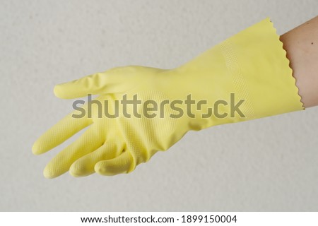 hand in a protective rubber glove