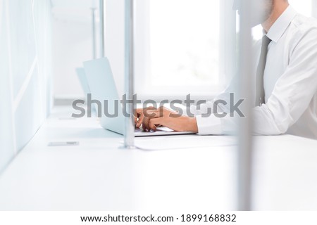 background image of a business man working on an office laptop .