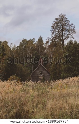 Abandoned wooden church in the Latvian countryside. Wooden architectural monument and valuable object. Landscape in the autumn mood.