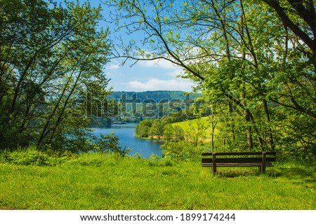 Rursee at Eifel National Park, Germany. Scenic view of lake Rursee and surrounded green hills in North Rhine-Westphalia Royalty-Free Stock Photo #1899174244