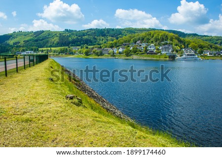 Village Rurberg at Eifel National Park, Germany. Scenic view of lake Rursee, Paulushofdamm and small town in the background