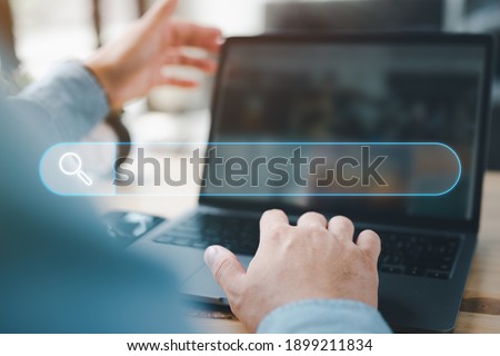Data Search Technology Search Engine Optimization. man's hands are using a computer notebook to Searching for information. Using Search Console with your website.