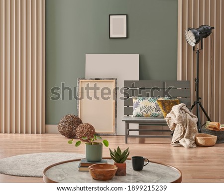 Close up marble design wooden middle table and green wall furniture grey chair poster frame and black lamp background concept.
