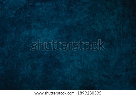 Dark blue grungy wall backdrop or texture 