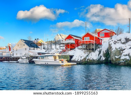 Traditional Norwegian red wooden houses (rorbuer) on the shore of  Reinefjorden near Hamnoy village.  Location: Hamnoy, Lofoten; Norway, Europe