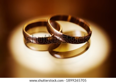 gold wedding rings on a glass surface. preparing for the wedding. close-up, macro