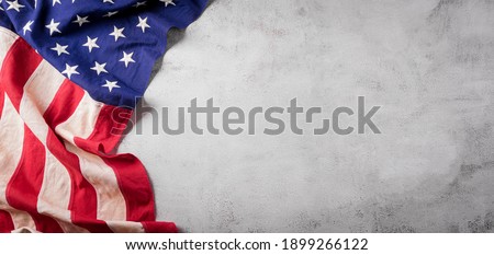 Happy presidents day concept with flag of the United States on old stone background. Royalty-Free Stock Photo #1899266122