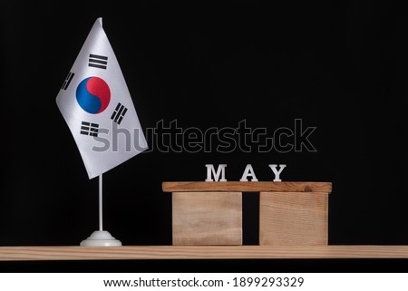 Wooden calendar of May with South Korea flag on black background. Dates of South Korea in May.