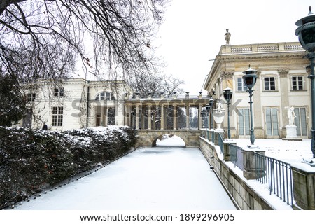 beautiful historic palace on the water in Łazienki Królewskie park in Warsaw, Poland during snowy winter