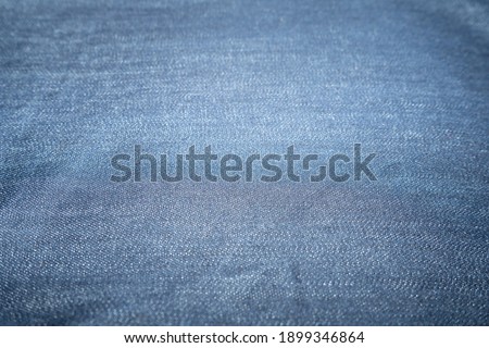 The background is a denim fabric. jeans fabric close up.