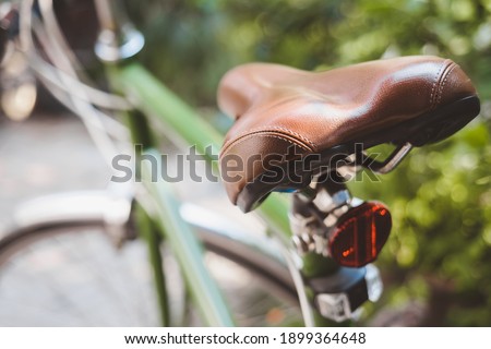 Selective focus on the brown saddle as bike seat on the vintage bicycle