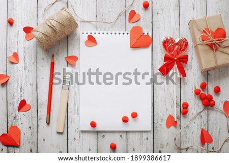 Happy Valentine's Day photography with gift box and paper origami heart on natural background. Romantic greeting card with place for your text.