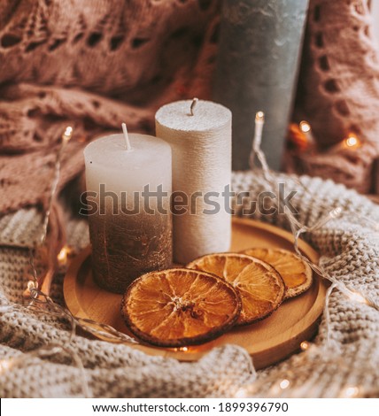 Christmas candle on on a stand with sliced ​​oranges