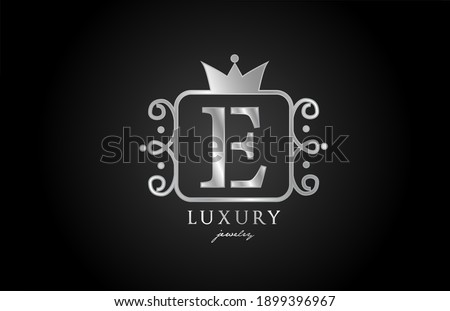 E monogram silver metal alphabet letter logo. Creative icon design with king crown for luxury business and company 