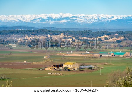 countryside landscape with snowy pyrenees in the background