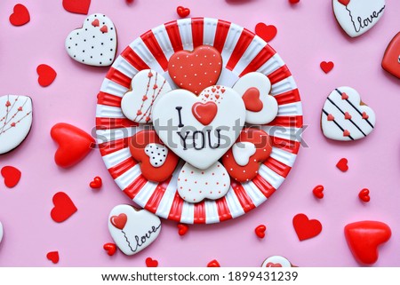 assortment of gingerbread in the form of hearts lies on a red-white plate. Sweet sweets with love. Gift for Valentine's Day. Valentine day.