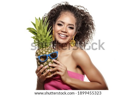 Model with pineapple in hands. African American Girl with Exotic Fruit. Cheerful woman with a smile relaxing on vacation. Image about summer time, smile and rest