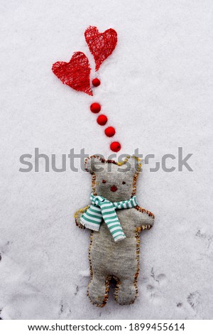 photo of cute teddy bear toy and heart on the snow