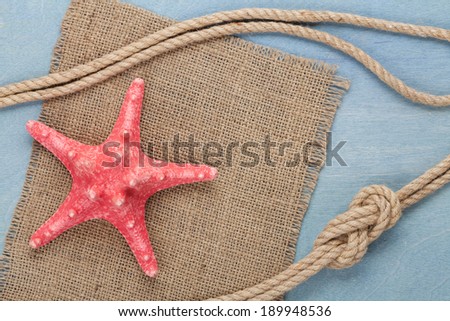 Sea travel frame decor with starfish and rope over wooden background