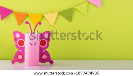 cute paper butterfly made from a toilet paper tube. spring background. recycling