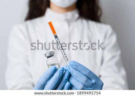 Doctor holding coronavirus vaccine. Close-up covid-19 Vaccination. Stop quarantine.