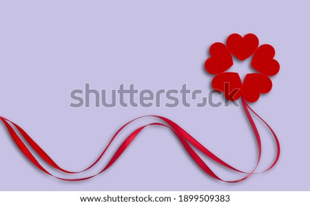 Red ribbons and hearts on gray-blue background
