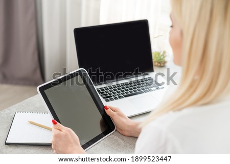 Businesswoman with Digital Tablet in Office, woman holding tablet