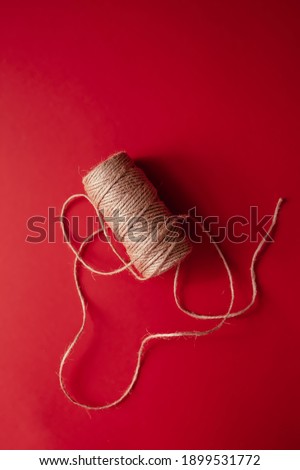 
skein of thread on a red background