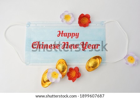 Handwriting of word Happy Chinese New Year. Inscription with gold, blossom flower on white background.  New year concept. Can use for slide presentation, greeting card and website.  Year of the Ox