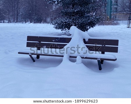 Snowman at dusk in MacDonald Gardens park Lowertown East. Ottawa Ontario Canada January 21 2021. 