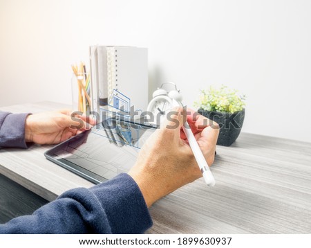 Man's hand using tablet pc while work on home, Technology Device for working