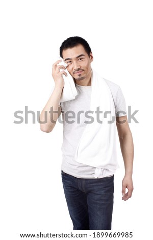 A happy young man wiping with towel high quality photo
