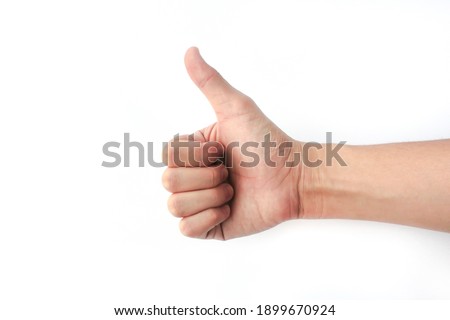 Hand of man showing thumb-up gesture on white background. Sign Fingers OK. Fingers "Good" on a white background along with a space for writing. Royalty-Free Stock Photo #1899670924