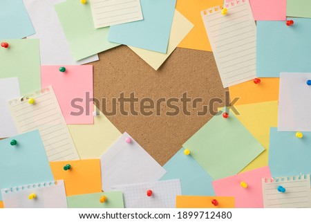 Happy St Valentines day concept. Photo of stack of multicolored stickers attached to the board making heart with blank empty space inside