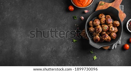 Fryed meatballs on black background, top view, copy space. Beef roasted meatballs ready for eat. Royalty-Free Stock Photo #1899730096
