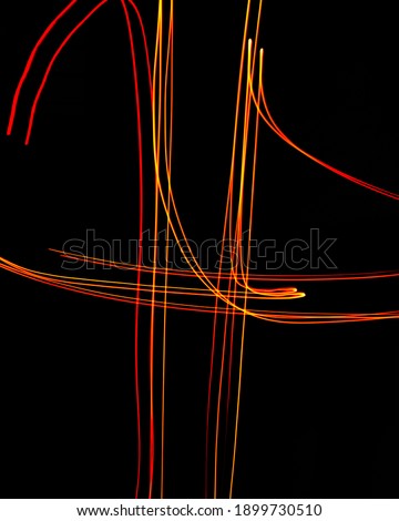 Creative conceptual fine art photography motion blur sparkle light trail on dark background copy space for text. Artistic design by lamp fire flame line at night slow shutter speed of camera exposure.
