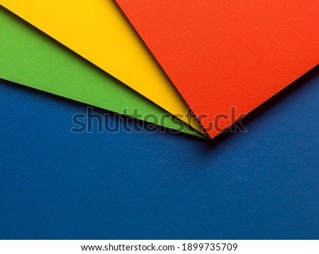 Colorful paper design with red, yellow and green on a blue background